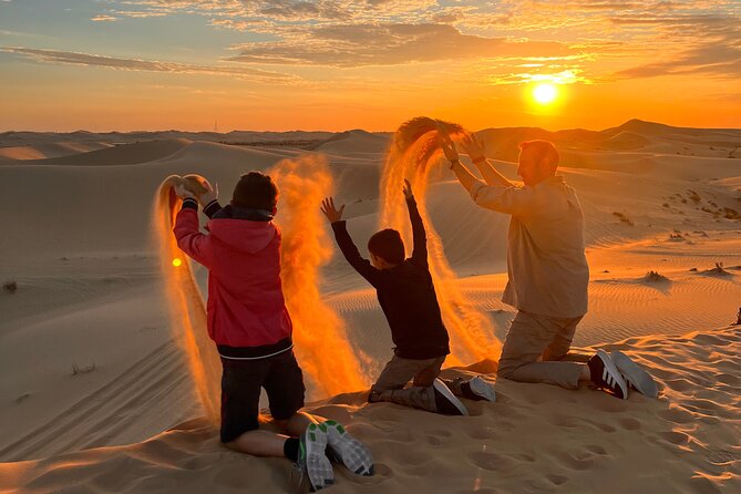 Desert Safari Abu Dhabi w/ Sand Boarding, Camel Ride & BBQ Dinner - Sunset photos across the dunes