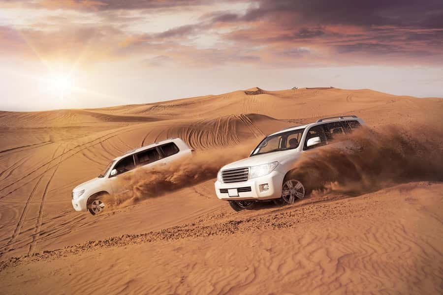Dubai: Desert Safari, Camel Ride, and BBQ Dinner - Sunset over the open sand