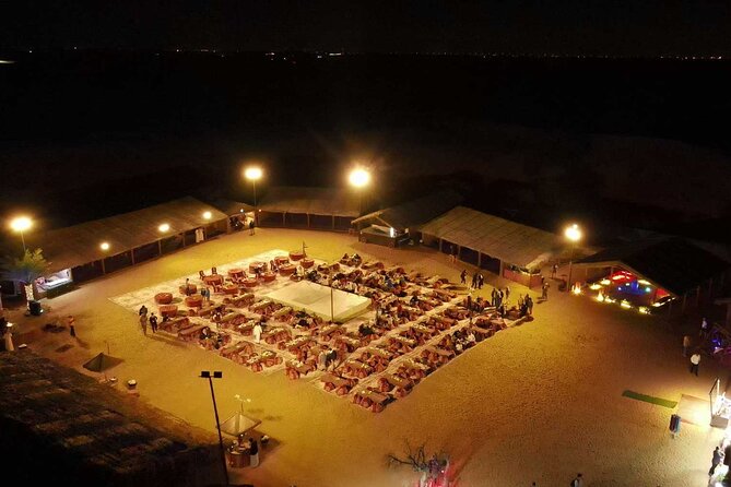 Dubai: Desert Safari, Camel Ride, Show & Optional Dinner - Sandboarding down a dune