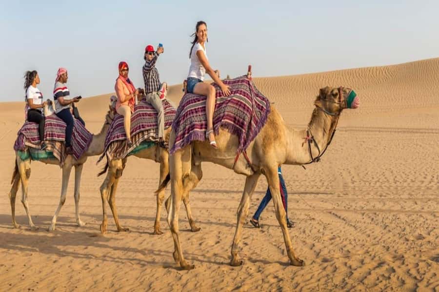 Dubai: Desert Safari Camel Riding, Sandboarding & BBQ Dinner - The first desert stop: tyres, photos, and optional quad biking