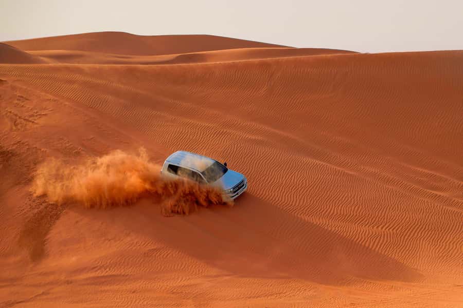 Dubai: Desert Safari, Quad Bike, Sandboarding, Camels & BBQ - Dune bashing delivers the biggest burst of adrenaline
