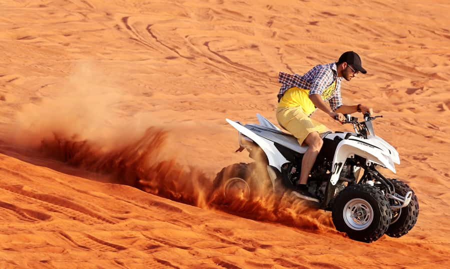 Dubai: Desert Safari, Quad Bike, Sandboarding, Camels & BBQ - The guide is the difference between smooth and scattered