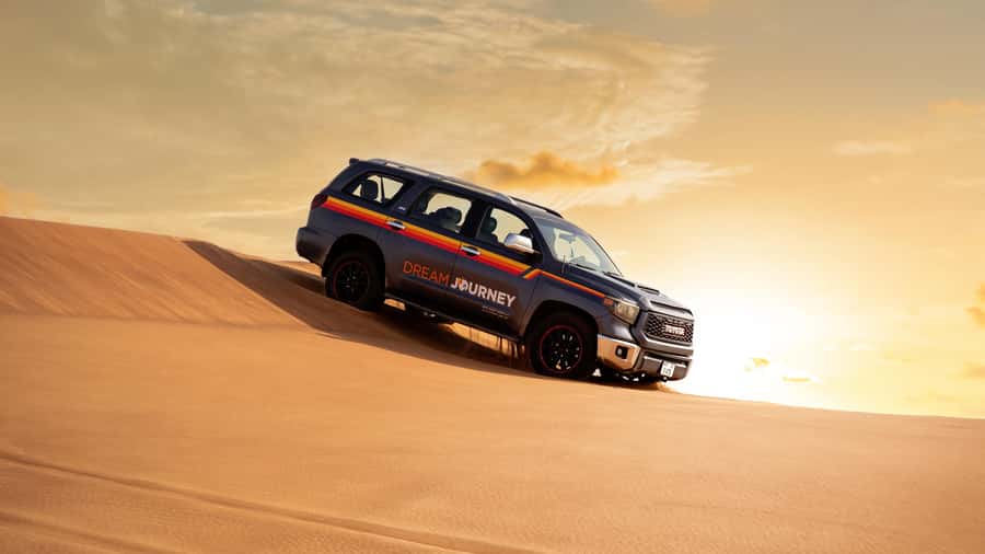 Dubai Desert Safari - Sandboarding, Quad Bike & BBQ Options - Sandboarding, sunset photos, and a short camel ride