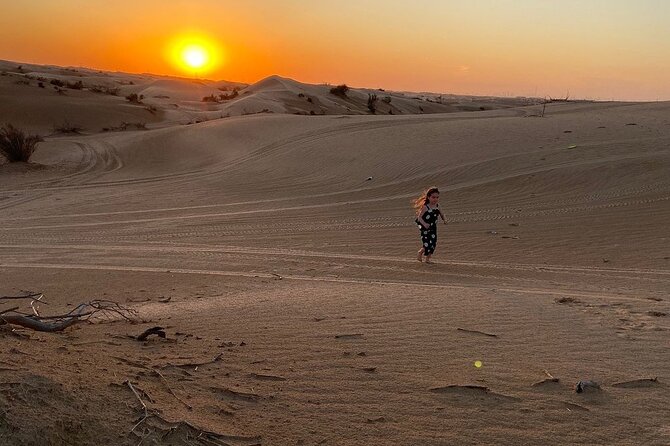 Dubai Desert Safari with Dune Bashing, Camel Ride, & BBQ Dinner - A short camel ride and a quick sandboard run