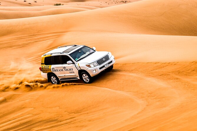 Dubai Desert Safari with Dune Bashing, Camel Ride, & BBQ Dinner - The Bedouin-style camp after sunset