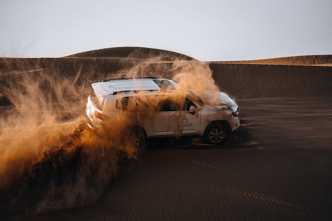 Dubai Evening Desert Safari: Sandboarding, BBQ, Camel Ride & more - Sunset on the conservation reserve