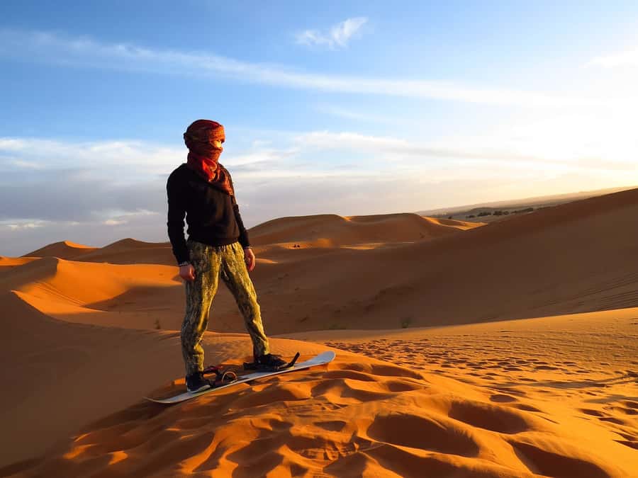 Dubai: Evening Tour with Quad Biking, Camel Ride, and BBQ - Sandboarding with wide desert views