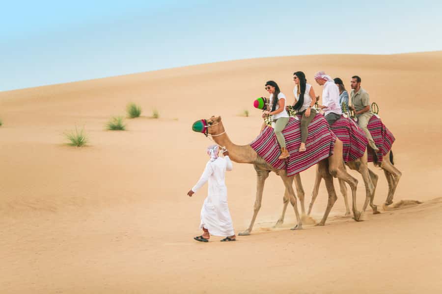 Dubai: Heritage Camel Desert Safari with Traditional Dinner - Riding through the dunes on a camel convoy