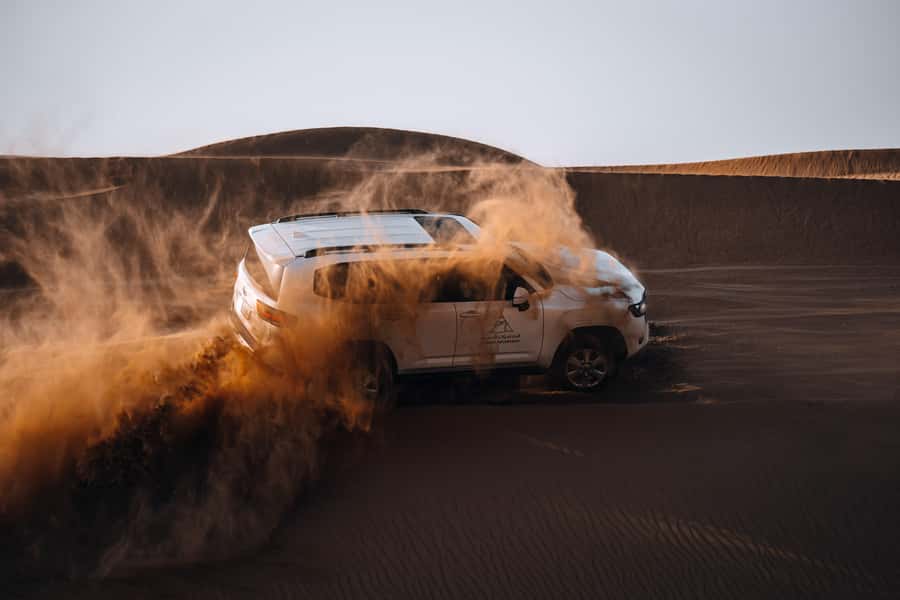 Dubai: Premium Desert Safari, Camel Ride, BBQ & Sandboarding - Dune bashing with a trained driver