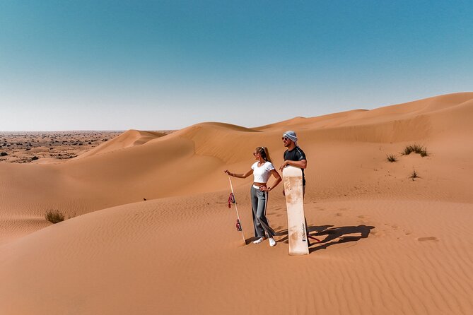 Dubai Red Dunes Safari: Dune Bashing, Camel Ride & Breakfast - Camel riding and sandboarding at camp