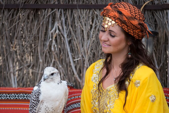 High Red Dunes with Camel Ride, Sandboarding, Falcon Show and VIP BBQ Dinner - Sunset, camels, and Bedouin-style seating