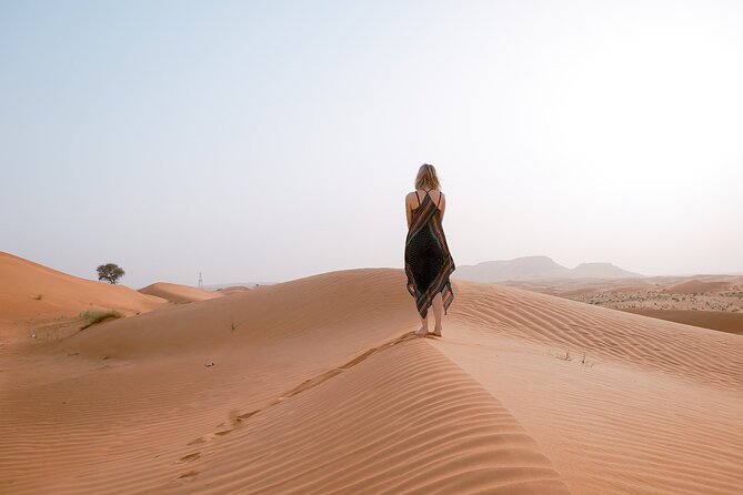 Morning Desert Safari From Abu Dhabi -Camel Ride,Sand Boarding,Camel Farm Visit - Sand boarding on a golden dune